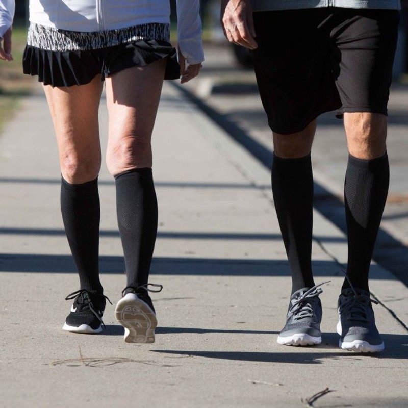 Two People Walking in Copper Fit Compression Socks