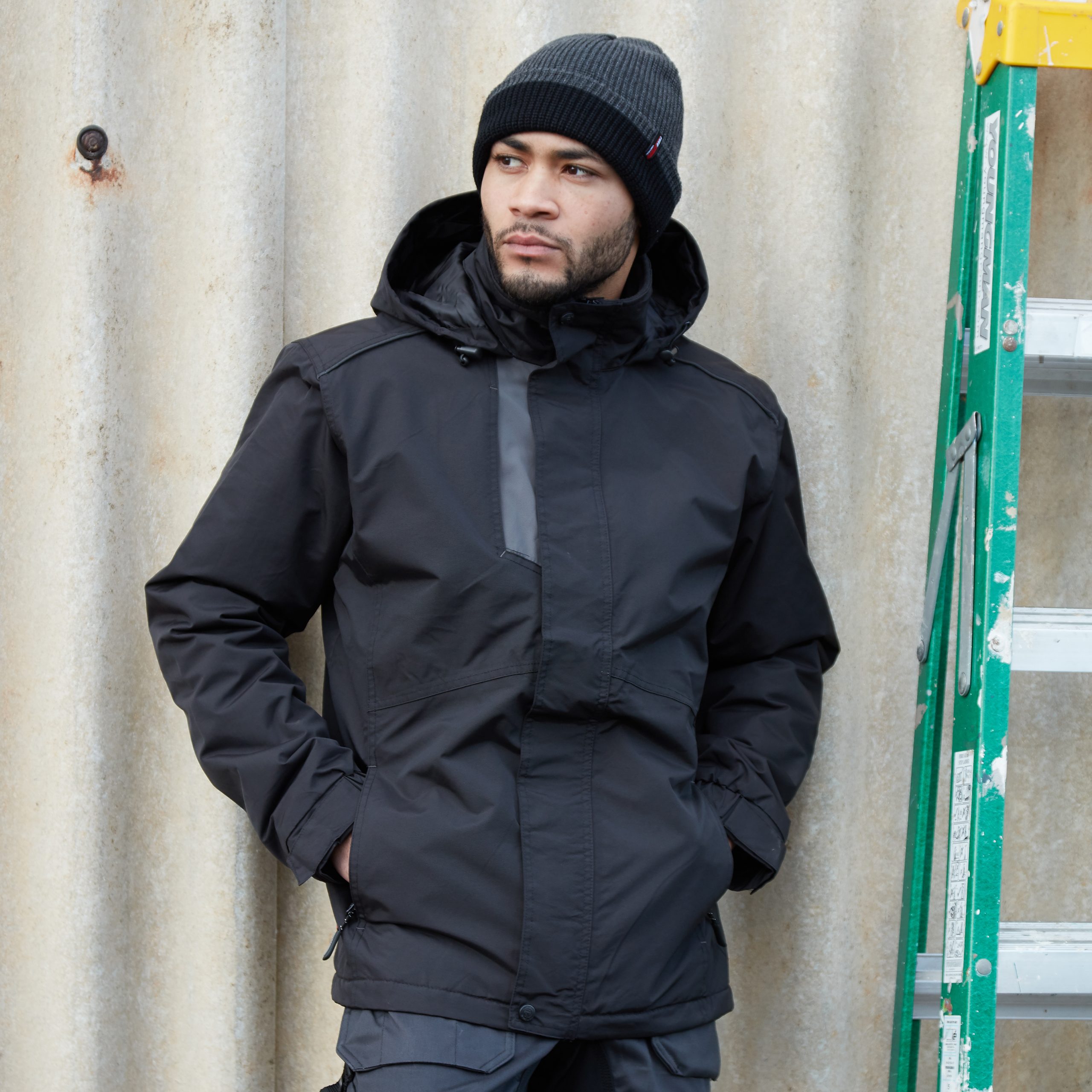 man wearing the tuffstuff 293 navy waterproof jacket